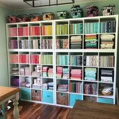 a room filled with lots of different types of fabrics and quilting material on shelves