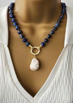 Elegant Lapis Lazuli and Baroque Pearl Necklace with Gold Accents - Statement Gemstone Jewelry Natural Stone Necklace , Lapis Lazuli Pearl Pendant Necklace Elevate your style with this exquisite handmade necklace featuring genuine lapis lazuli beads and a stunning baroque pearl pendant. The deep blue hues of lapis lazuli are beautifully complemented by gold-tone accents, adding a touch of sophistication to the design. The pendant showcases a unique baroque pearl with its organic shape and lustrous finish, making it a true statement piece. Perfect for both everyday elegance and special occasions, this necklace combines timeless materials with contemporary craftsmanship. Each gemstone is carefully selected to ensure premium quality, resulting in a truly one-of-a-kind accessory that embodies Lapis And Pearl, Pearl Necklace With Gold, Baroque Pearl Pendant, Gift For Mom Christmas, Natural Stone Necklace, Lapis Lazuli Necklace, Lapis Lazuli Beads, Everyday Elegance, Natural Stones Necklace