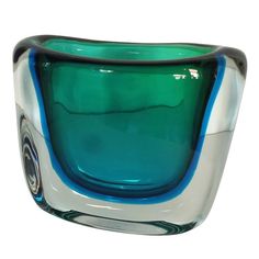 a blue and white glass bowl sitting on top of a table