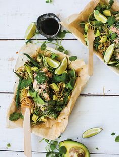 two bowls filled with food on top of a white table