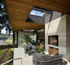 an outdoor living area with furniture and a fire place