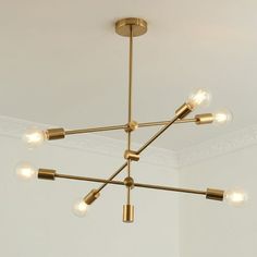 a chandelier with five lights hanging from the ceiling