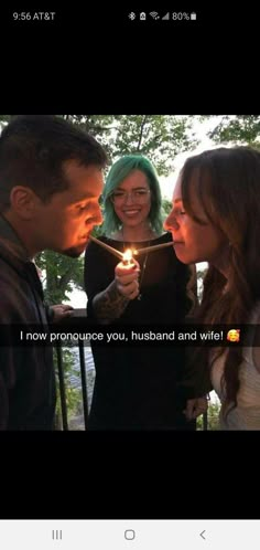 two girls and a man holding a lit candle with the caption, i now pronounce you, husband and wife