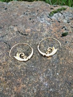 A pair of geometric earrings made of metal alloy. Unique Small Hoop Metal Earrings, Gold Spiral Earrings For Pierced Ears, Spiral Metal Wrap Earrings, Metal Spiral Wrap Single Earring, Swirl Earrings For Pierced Ears, Modern Jewelry With Unique Spiral Design, Metal Spiral Wrap Earrings, Swirl Shaped Metal Earrings As Gift, Gold Swirl Earrings For Pierced Ears