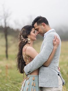 a man and woman standing next to each other in a field