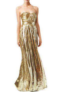 a woman is wearing a gold dress