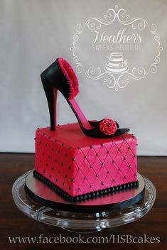 a pink cake with high heel shoes on top