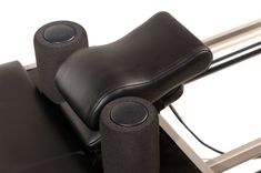 a black leather chair with two speakers on it