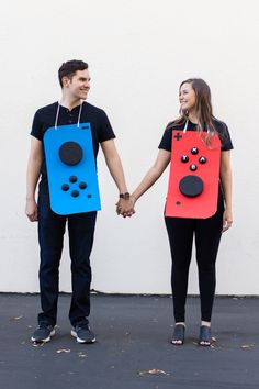 a man and woman holding hands while wearing homemade costumes