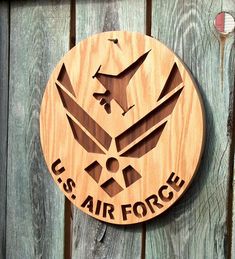 the u s air force emblem is carved into wood