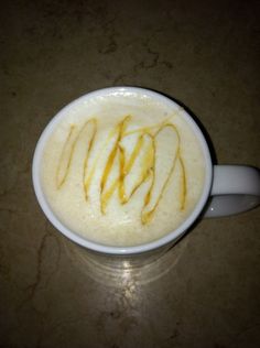 a cup filled with liquid sitting on top of a table