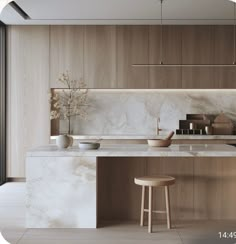 a kitchen with marble counter tops and stools next to an island in the middle