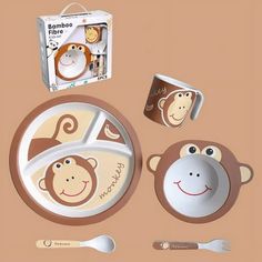 a set of children's dinnerware with monkey design