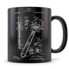 a black coffee mug with a drawing of a wrench and screwdriver on it