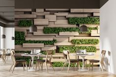 the interior of a restaurant with wooden tables and chairs, green plants on the wall