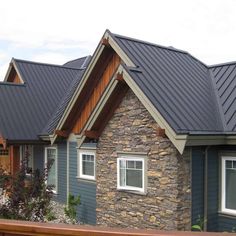 a row of houses with slate shingles and wood trimmings on the roof