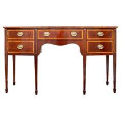 an antique wooden desk with three drawers on one side and two brass knobs on the other