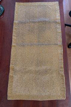 a brown rug sitting on top of a wooden floor next to a black chair and table