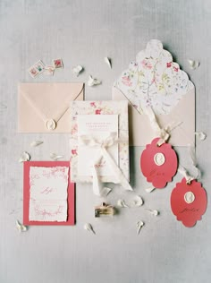 the wedding stationery is laid out on top of the table with confetti