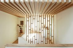 the interior of a house with wood slats on the ceiling and stairs leading up to the second floor