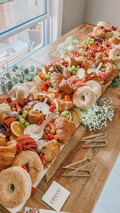 a wooden table topped with lots of different types of pastries