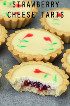 several small tarts sitting on top of a table with the words strawberry cheese tarts