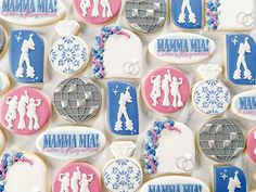 decorated cookies with the names of different people and symbols are displayed on a white surface