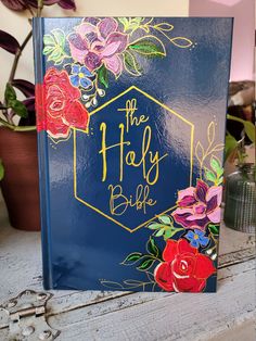 a blue book with flowers painted on it