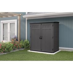 an outdoor storage shed in front of a house