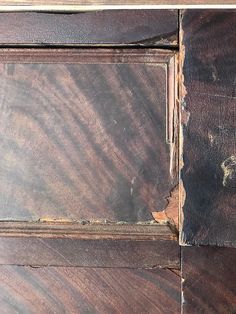 an old wooden door with peeling paint on it