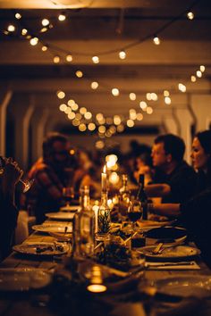 a group of people sitting around a dinner table