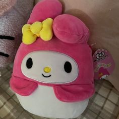 a hello kitty stuffed animal with a bow on its head