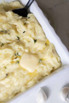 mashed potatoes with butter and herbs in a white dish