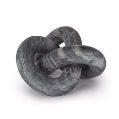 two black and white marbled objects on a white background, one is shaped like a knot