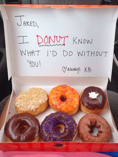 six donuts are in a box with writing on the front and back side,