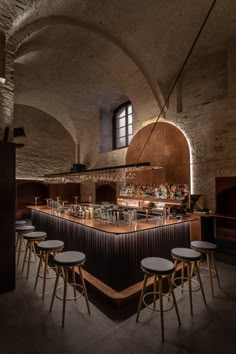 an empty bar with stools next to it