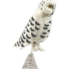 an owl figurine sitting on top of a wire cone