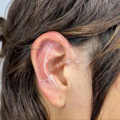 a close up of a person with ear piercings on their ears and behind the ear