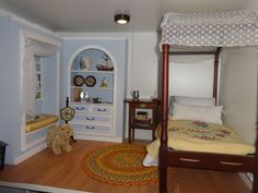 a doll house bedroom with bed, dresser and teddy bear