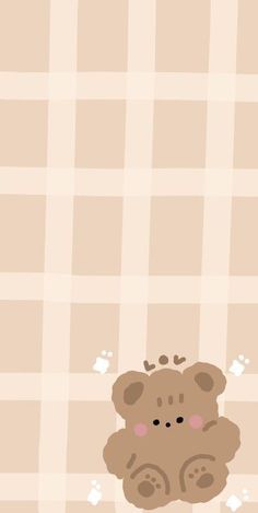 a brown teddy bear sitting on top of a checkered tablecloth with paw prints