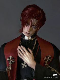 a man with red hair wearing a black and red outfit holding his hands to his chest