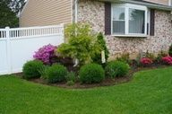 an image of landscaping in front of a house with the caption's description below