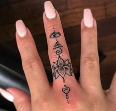 a woman's hand with a small tattoo on it