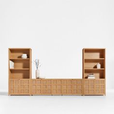 a wooden shelf with two open shelves next to each other and a vase on top