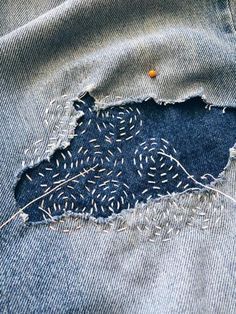 an old pair of jeans has been stitched together