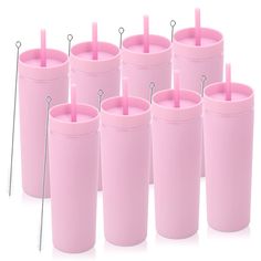 a set of six pink tumblers with straws in them