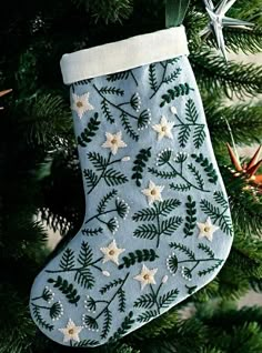 a blue christmas stocking hanging from a tree