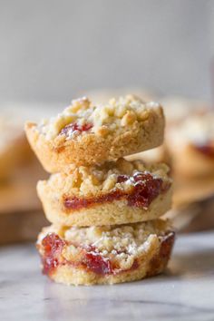 three cookies stacked on top of each other with cranberry filling in the middle