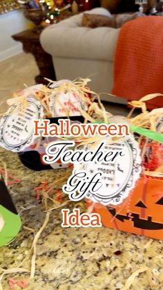 halloween teacher gift idea with pumpkins and paper tags on the table in front of a couch