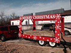 a red truck with a christmas sign on it's flatbed